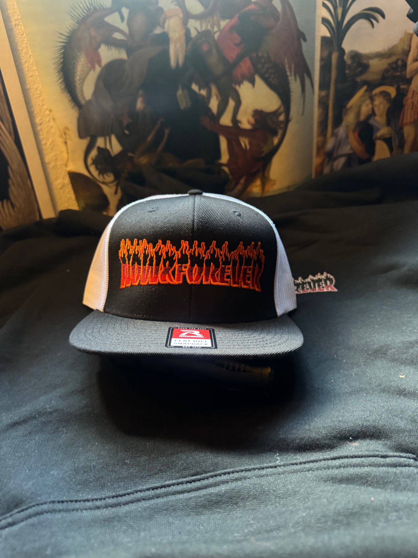 Flame logo trucker cap, alternate view showing the mesh back panel and snapback closure