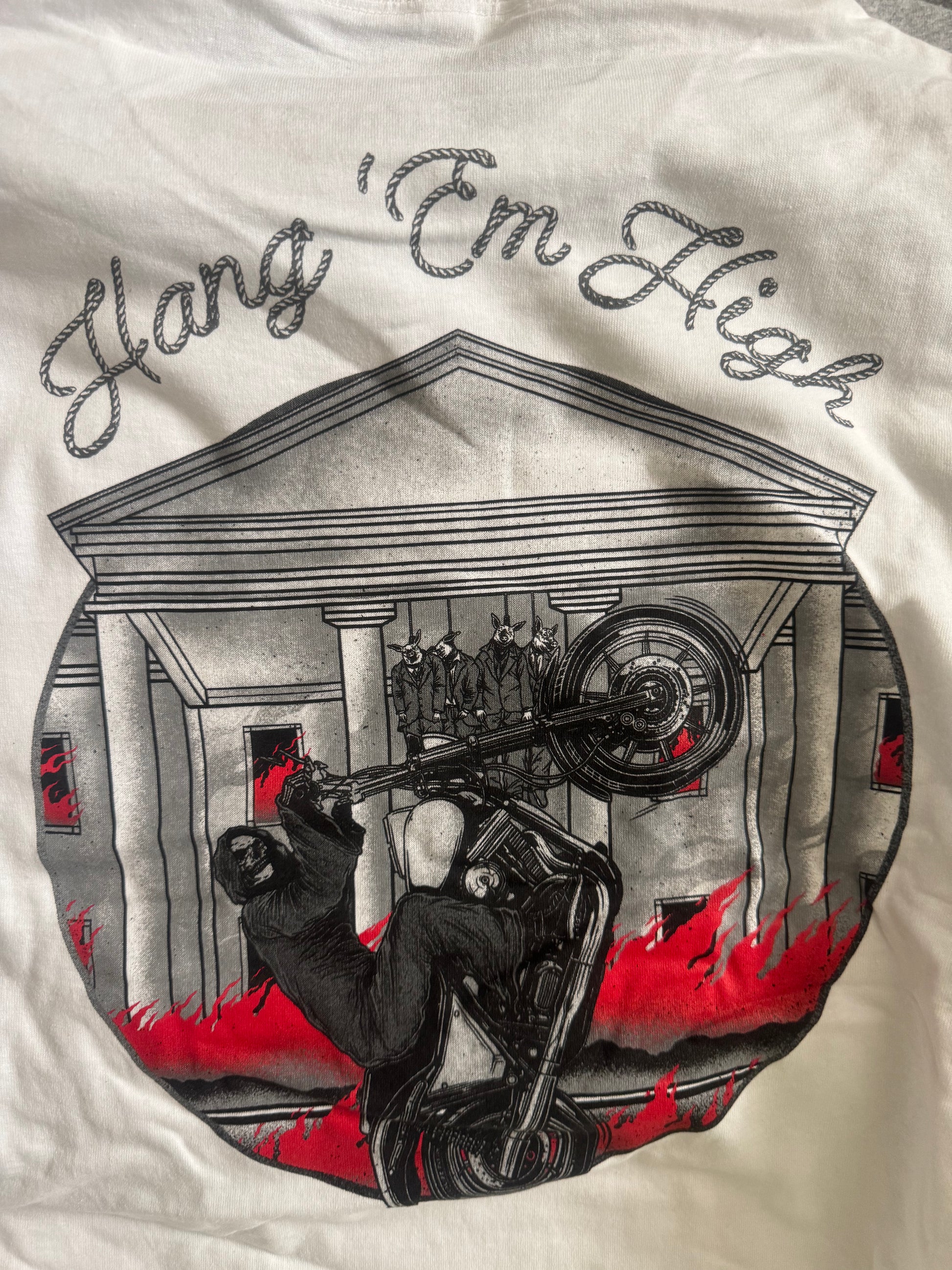 Hang 'Em High tee — Now & Forever Industries original artwork, a motorcycle at the center with suited pig figures strung up above it